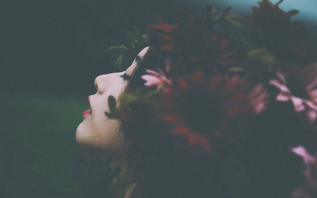 Side portrait of woman with flowers in hair.