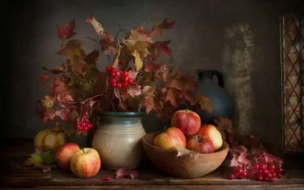 Still life with applles and scarlet viburnum autumn branches and berries in vintage style.