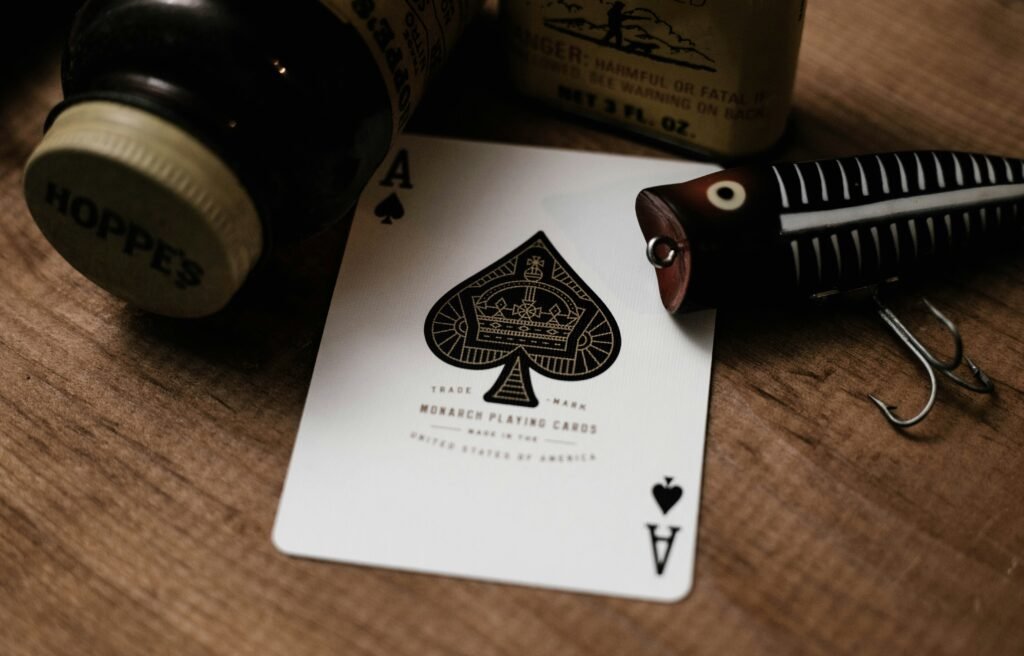 Vintage playing card ace of spades surrounded by fishing gear
